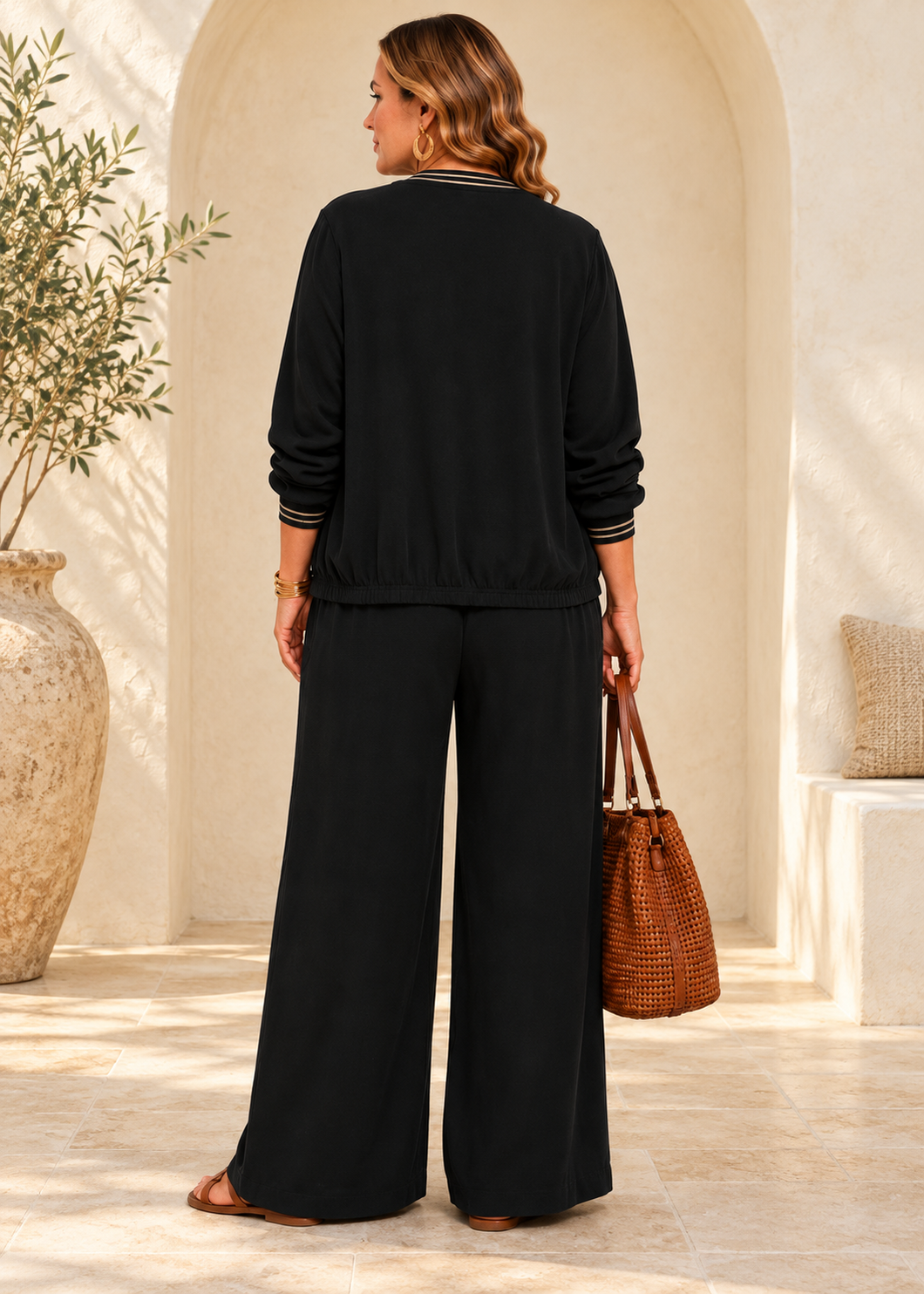 Rear view of black wide-leg viscose palazzo pants showing full-length flowing silhouette