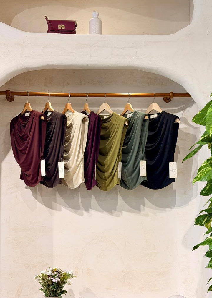 Italian Draped Top — draped sleeveless tops in assorted colors on hangers