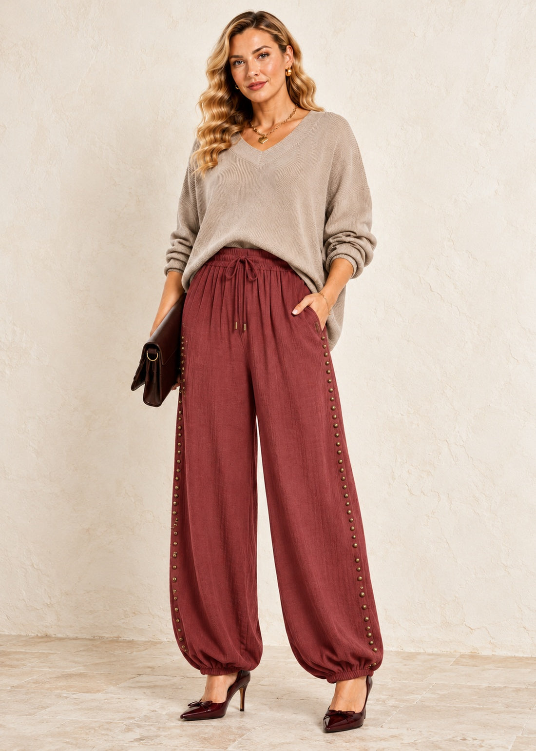 burgundy viscose balloon jogger pants with staggered antique brass studs and elastic ankle cuffs