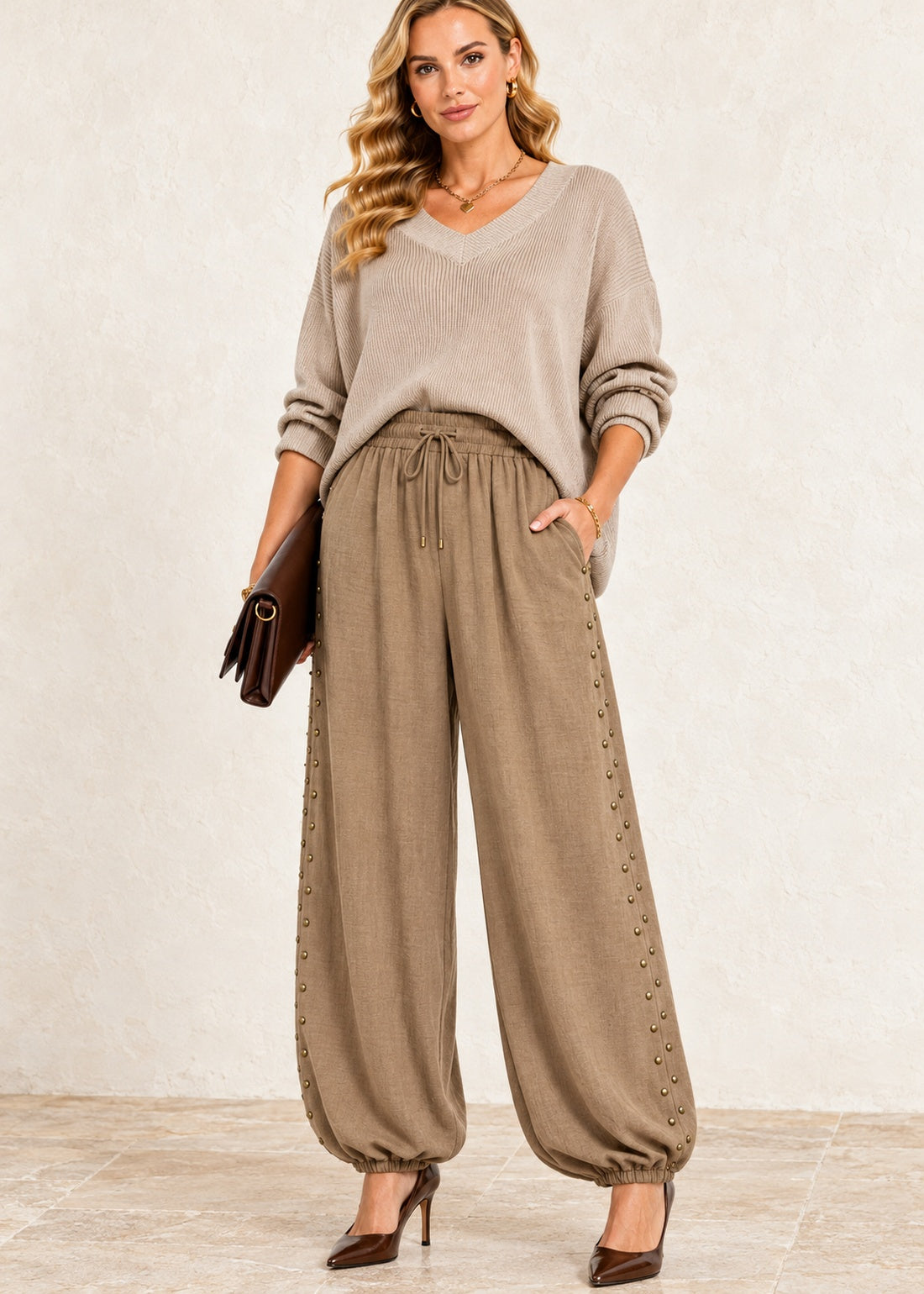 Muted camel viscose balloon jogger pants with staggered antique brass side studs and elastic ankle cuffs