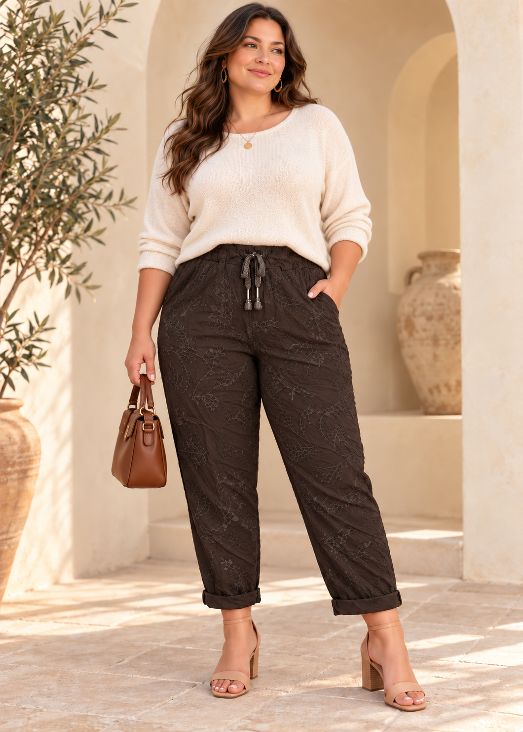 Curvy model wearing dark brown Italian Magic botanical pants, One Size L–2XL, styled with heeled sandals