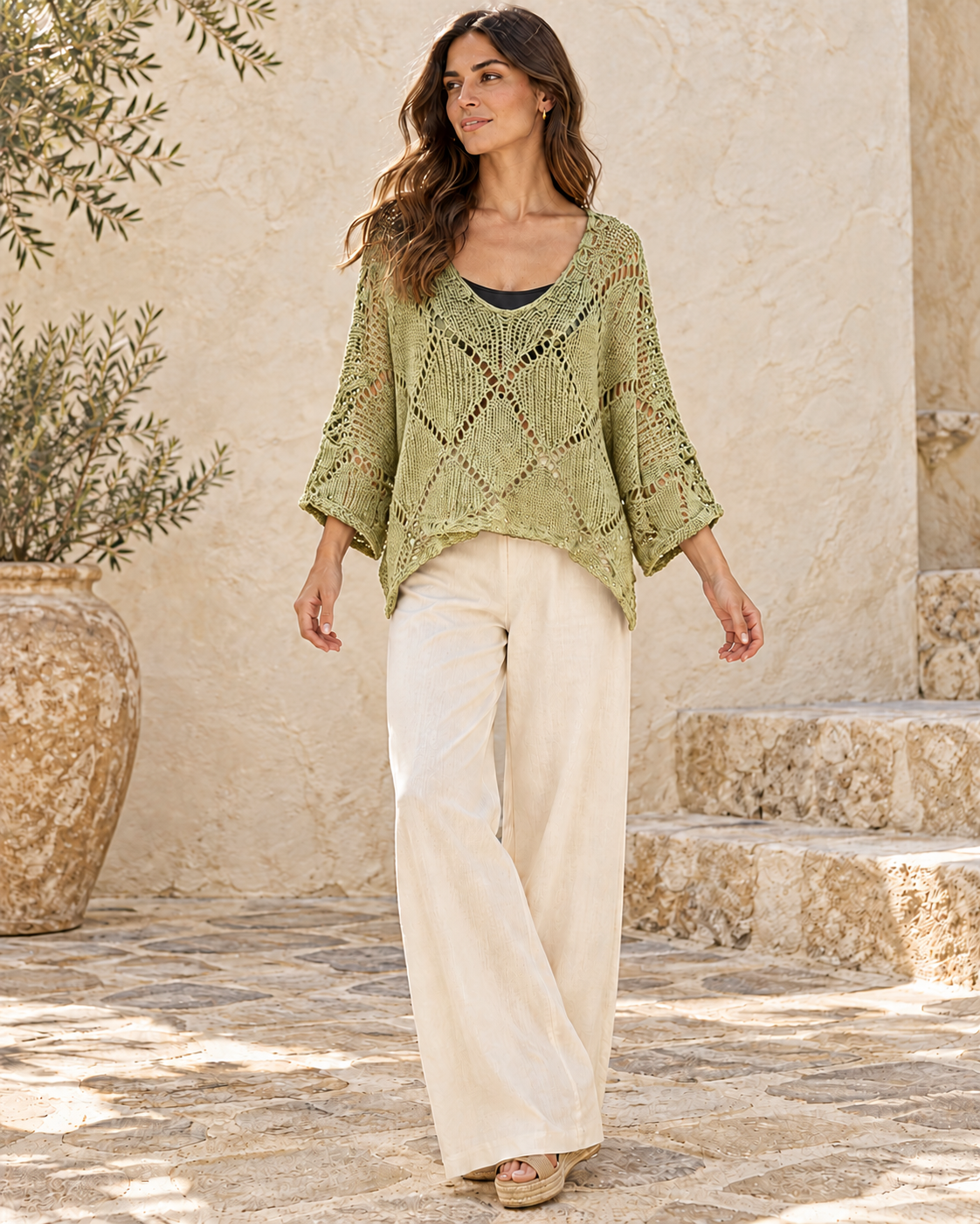 Anise green cotton crochet knit pullover styled with ivory trousers