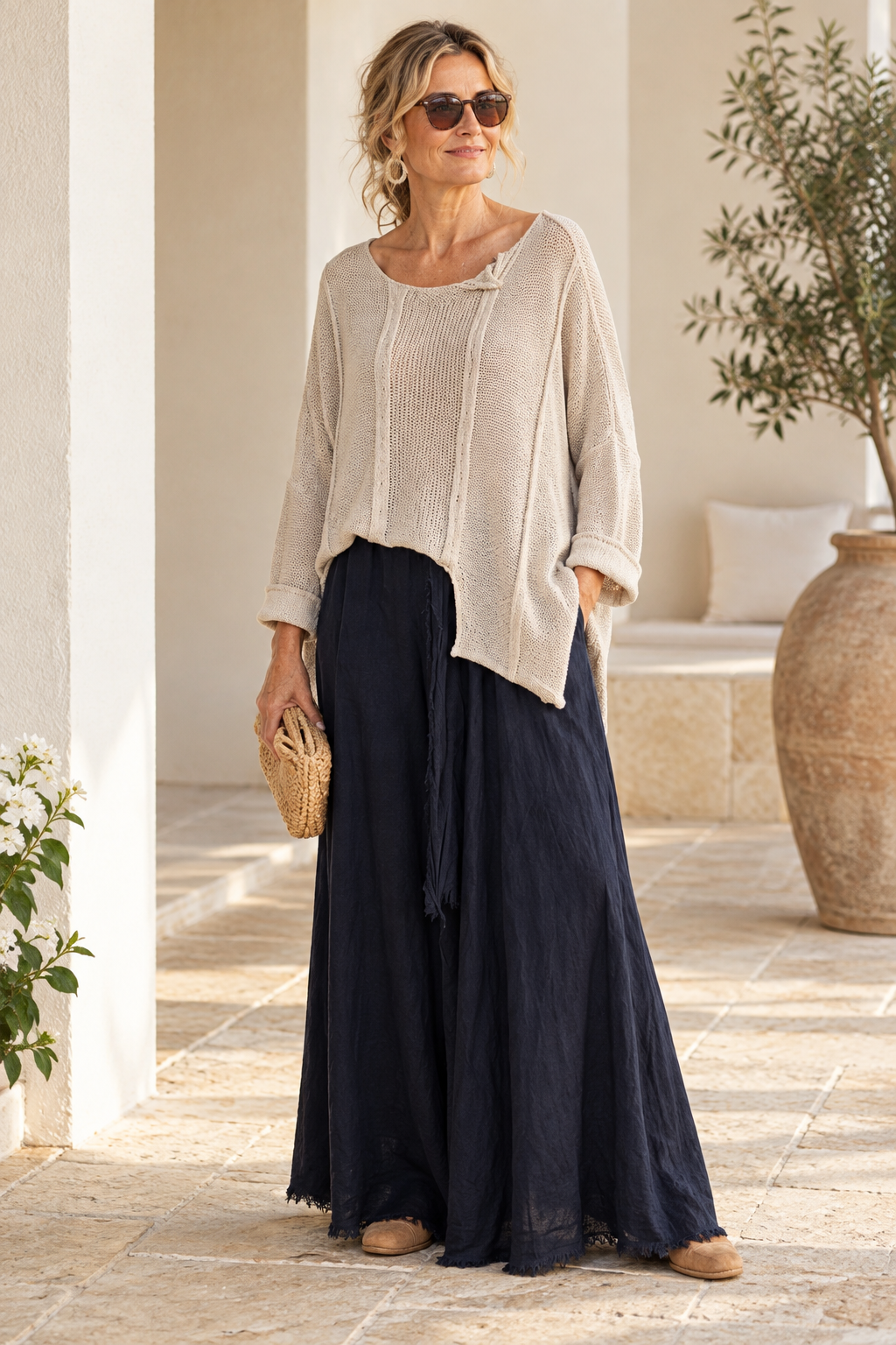 Beige Italian cotton poncho sweater on a model, showing asymmetric front hem and folded neckline detail